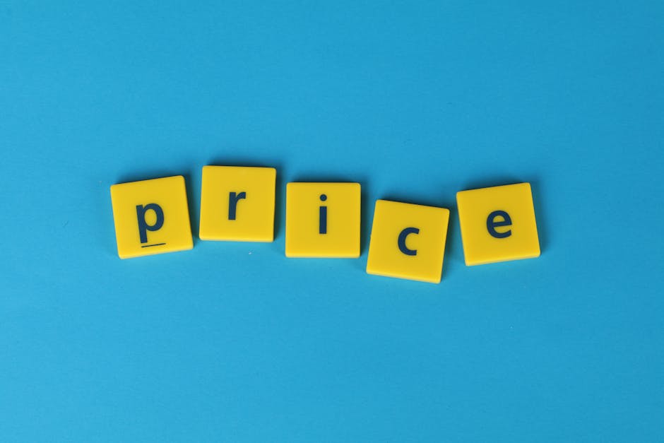 A close-up view of five yellow plastic letter tiles arranged on a light blue background. The tiles spell out the word 'price' with each letter printed in black. The tiles are slightly tilted and space